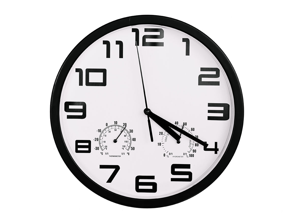 Black and white wall clock with the hands set to 4:20