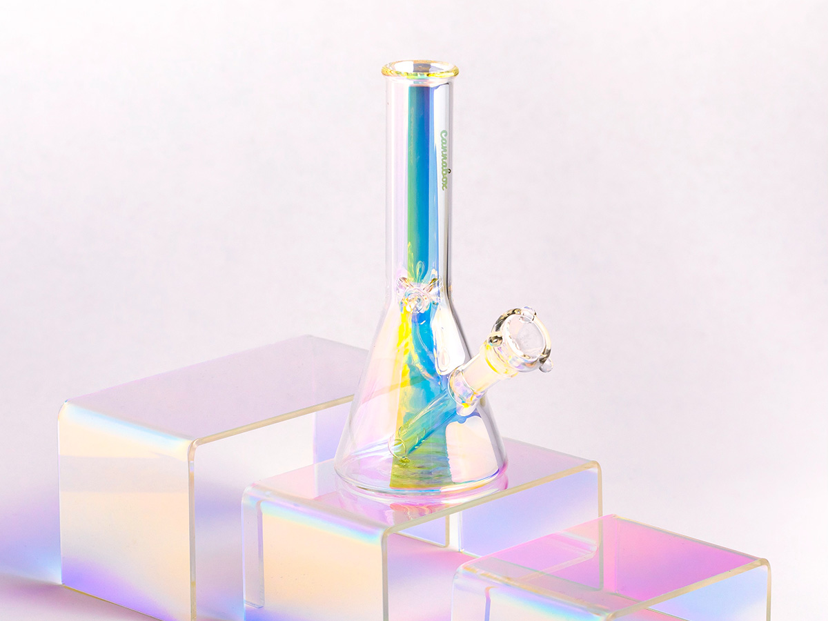 Colorful bong on a pink plastic shelf in front of a pink background