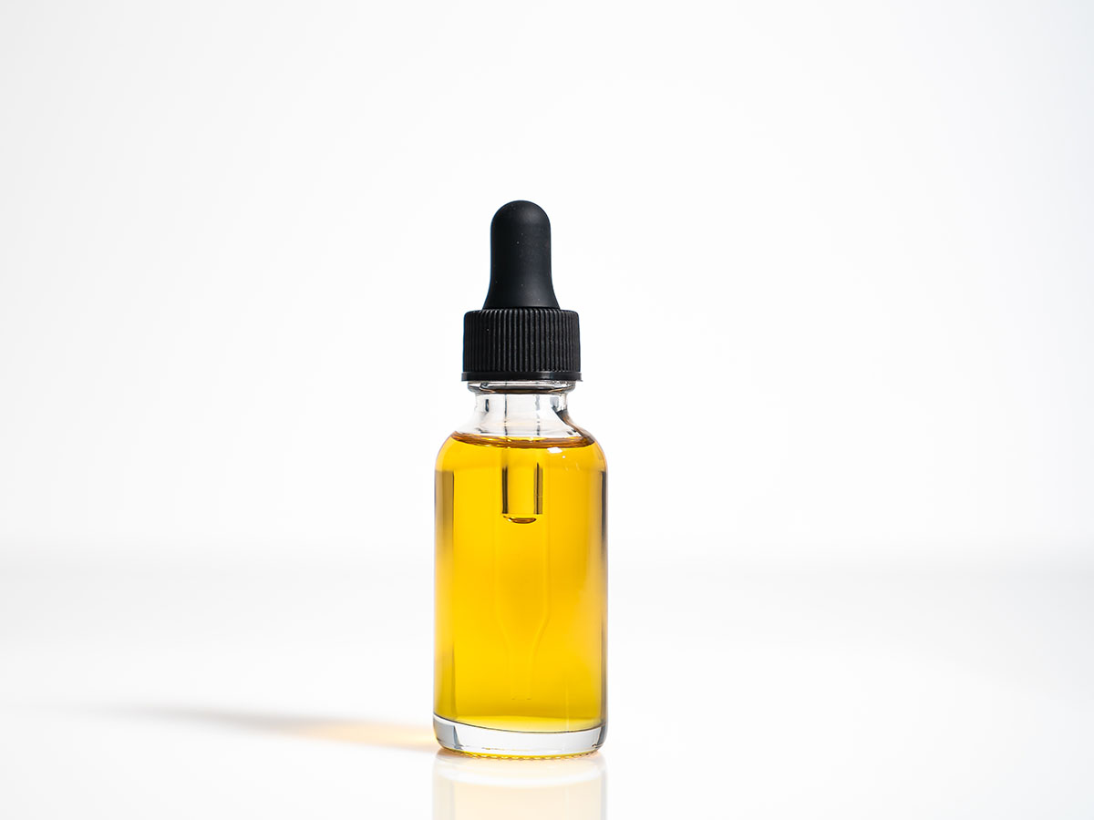 Glass tincture bottle with amber liquid inside