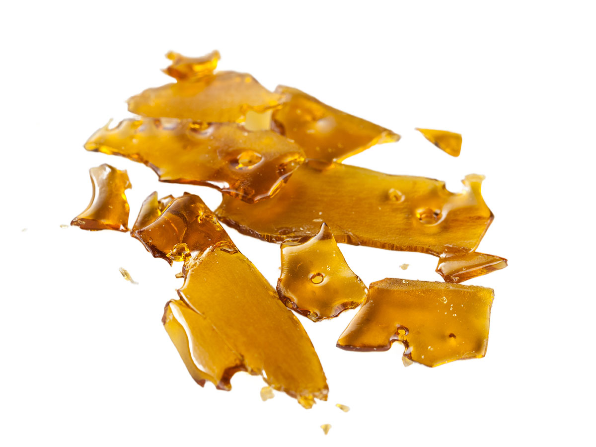 Pieces of shatter concentrate on a white background