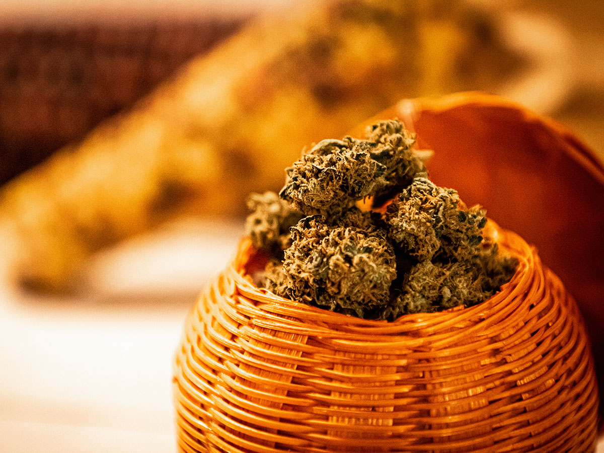 Cannabis flower flowing out of an orange basket