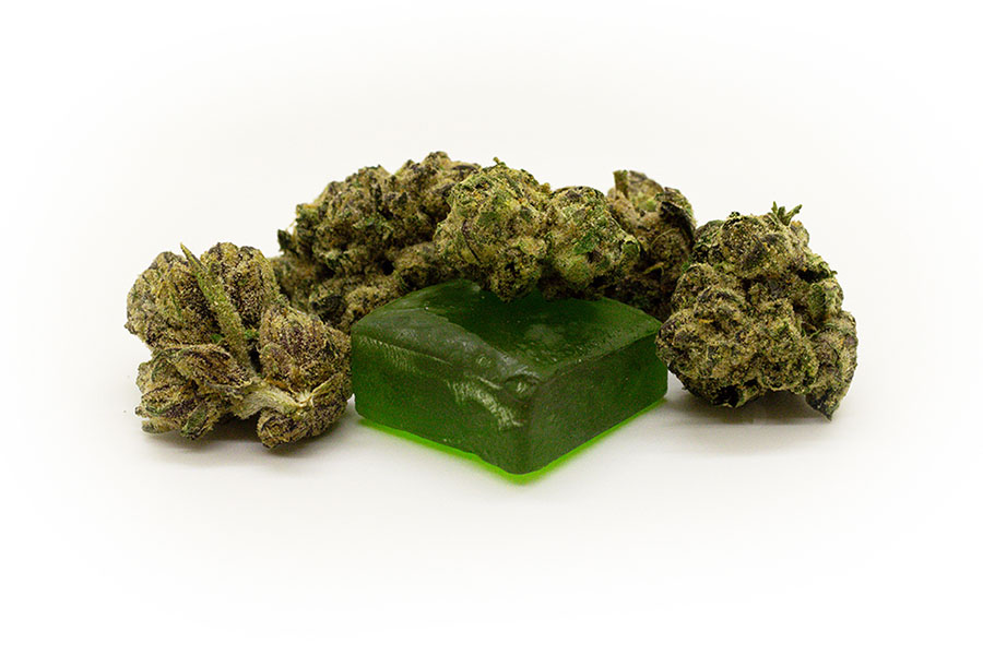 Cannabis flower buds surrounding a green gummy