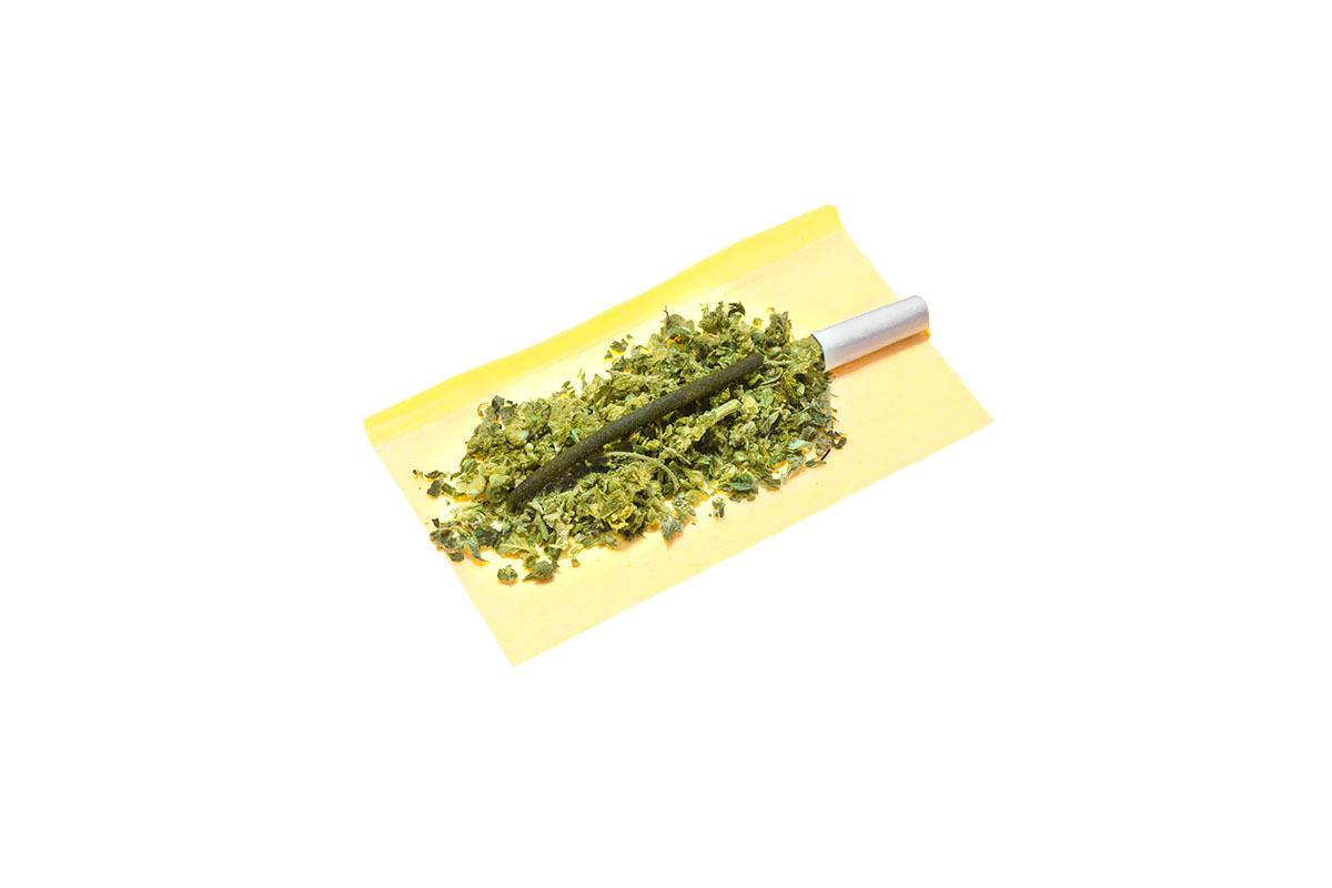 Infused pre-roll being rolled in paper with a filter