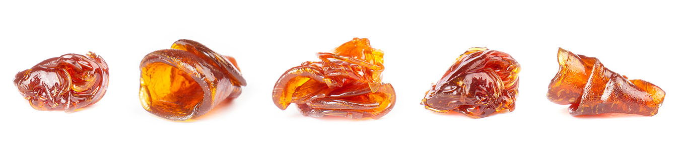 Five blobs of live resin next to each other on a white background