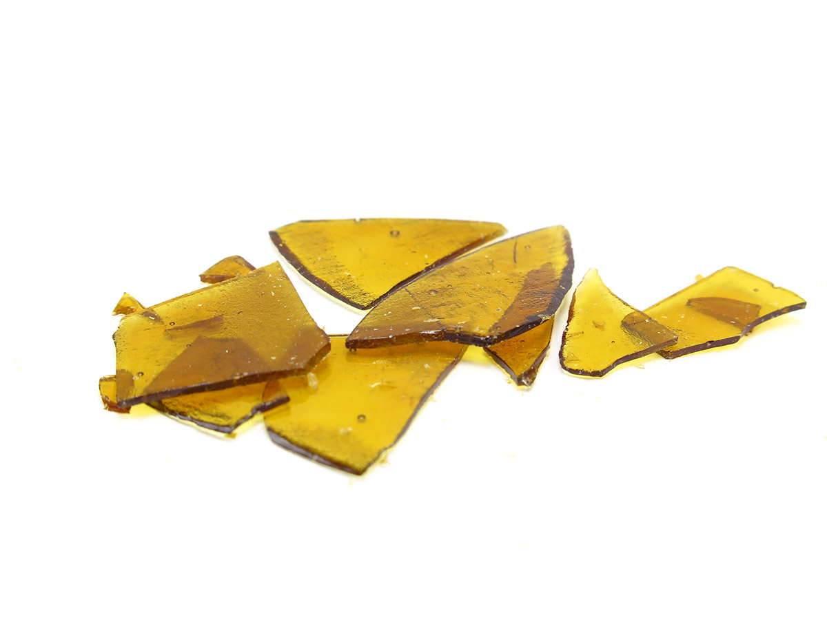 Pieces of shatter concentrate on a white background