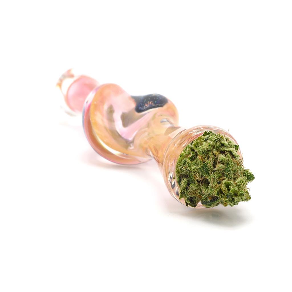 Pink glass one-hitter with a small amount of cannabis in the bowl