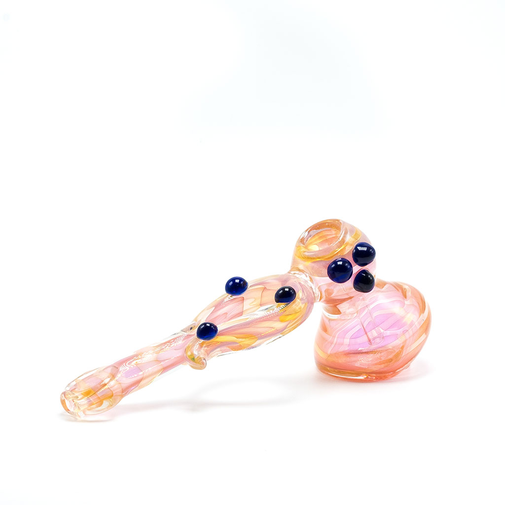 Pink and orange glass marijuana pipe with blue dots along the sides