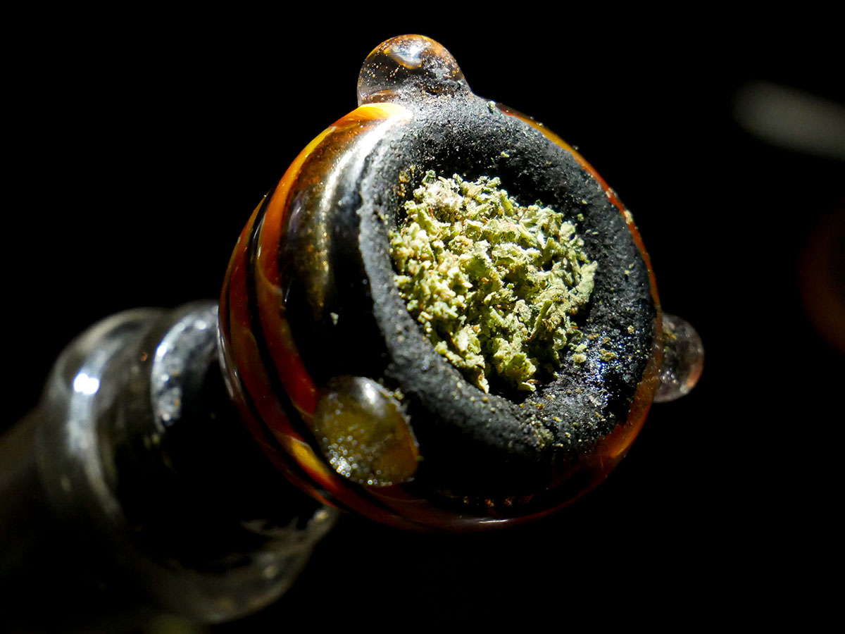Closeup on a cannabis bowl on a glass bong